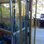 A small profile folding gate between the greenhouse and cottage creates a cat pen so Nova can go in/out as she pleases.
